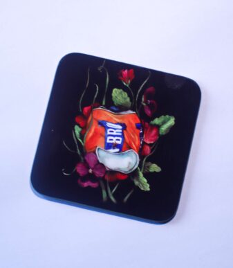 A Scottish coaster which depicts a watercolour painting of an IRN BRU can surrounded by wild Scottish flowers. Shop Scottish Gifts at Aff Yer Rocket.